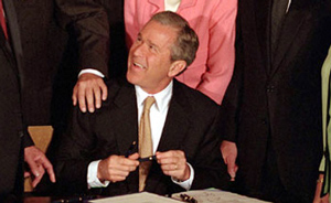 George W. Bush signing tax cut legislation