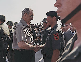 Lyndon Johnson shaking the hand of a U.S. GI