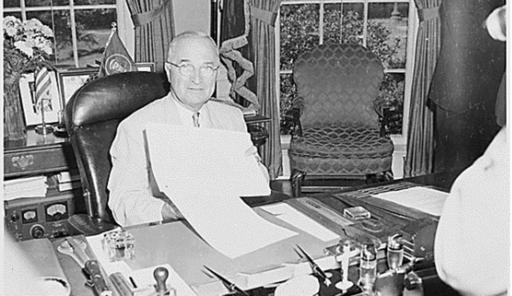 Truman displaying the National Security Act Amendments of 1949