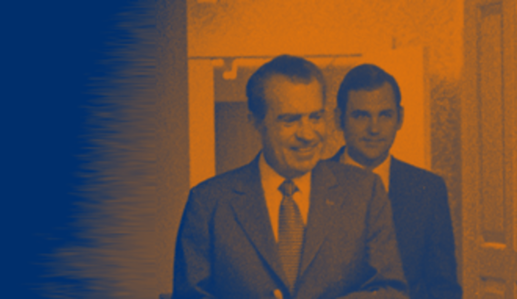 Richard Nixon with Ronald Ziegler over his shoulder in orange and blue