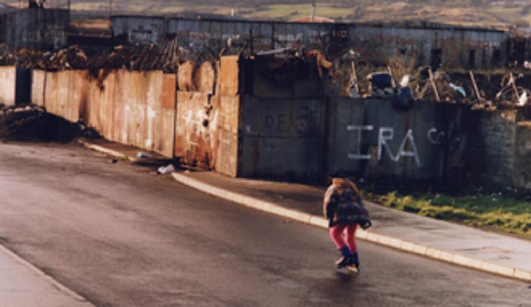 Roller skater on the Catholic side of the Belfast Peace wall