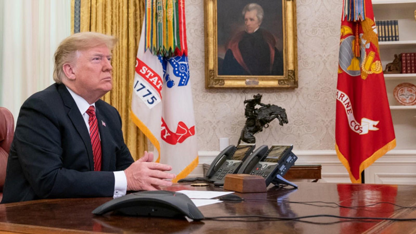 President Trump sits in the Oval Office